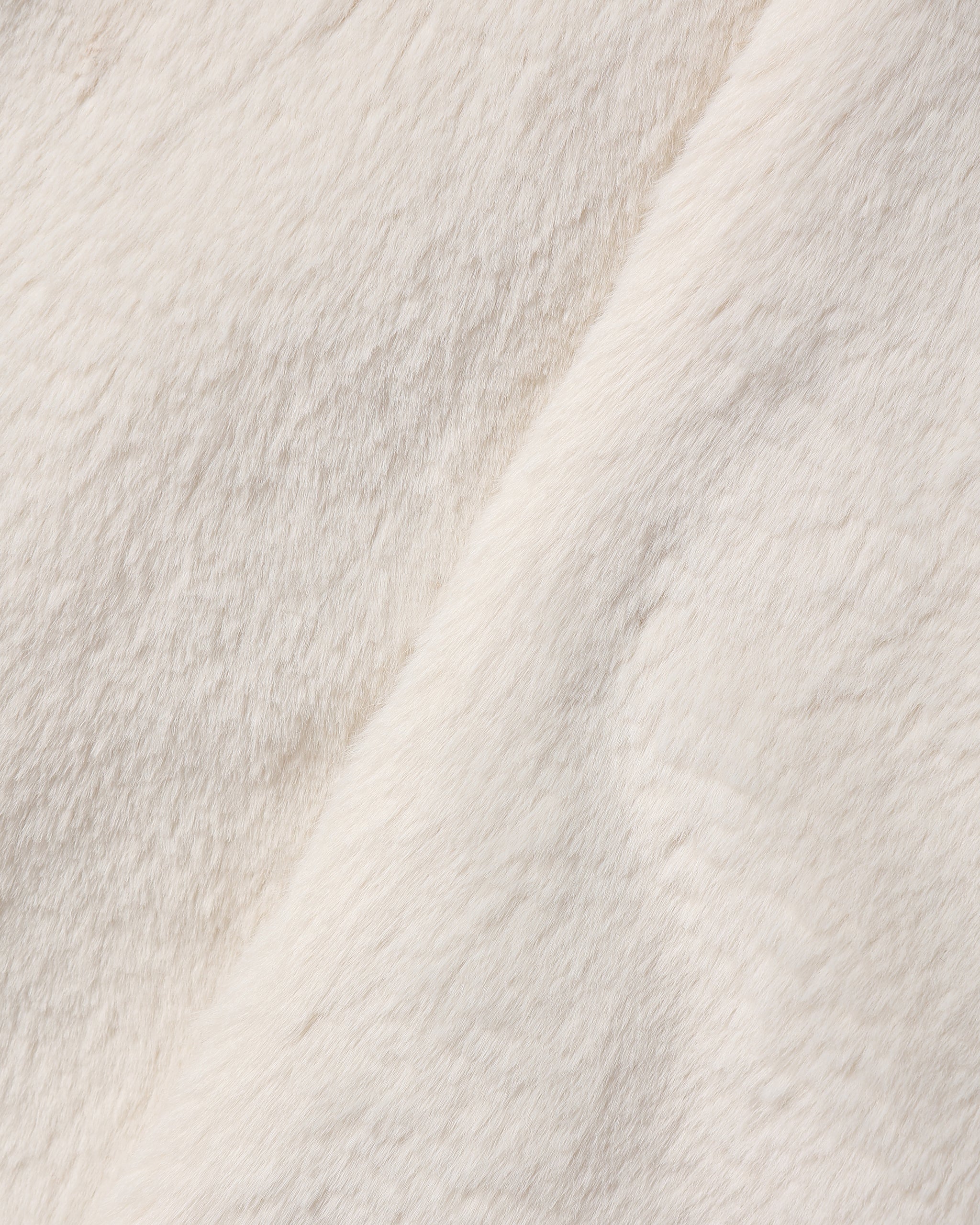 Close up of soft natural colored faux fur fabric from a Noralee children’s coat with a plush texture and warm neutral tone