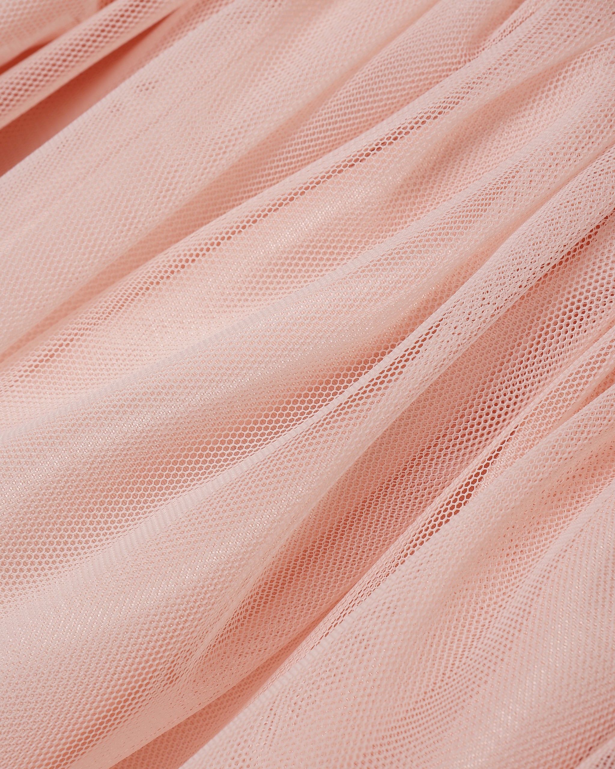 Close-up of pink tulle fabric with a soft texture