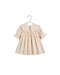 A cream-colored baby dress with a large embroidered Peter Pan collar, short puff sleeves, and a scalloped hem, hanging on a metal hanger against a white backgroundl.