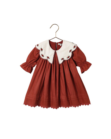 Noralee ruby red girls dress with a scalloped embroidered white collar long sleeves gathered skirt and scalloped hem displayed on a hanger