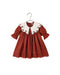 Noralee ruby red girls dress with a scalloped embroidered white collar long sleeves gathered skirt and scalloped hem displayed on a hanger