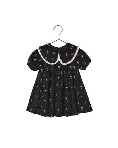 Noralee black floral girls dress with a white lace trimmed oversized collar puff sleeves and a softly gathered full skirt on a hanger
