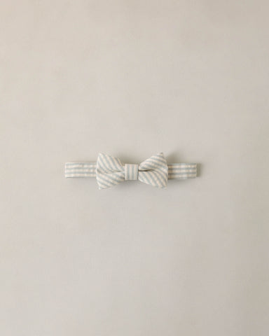 Striped bow tie on a beige background
