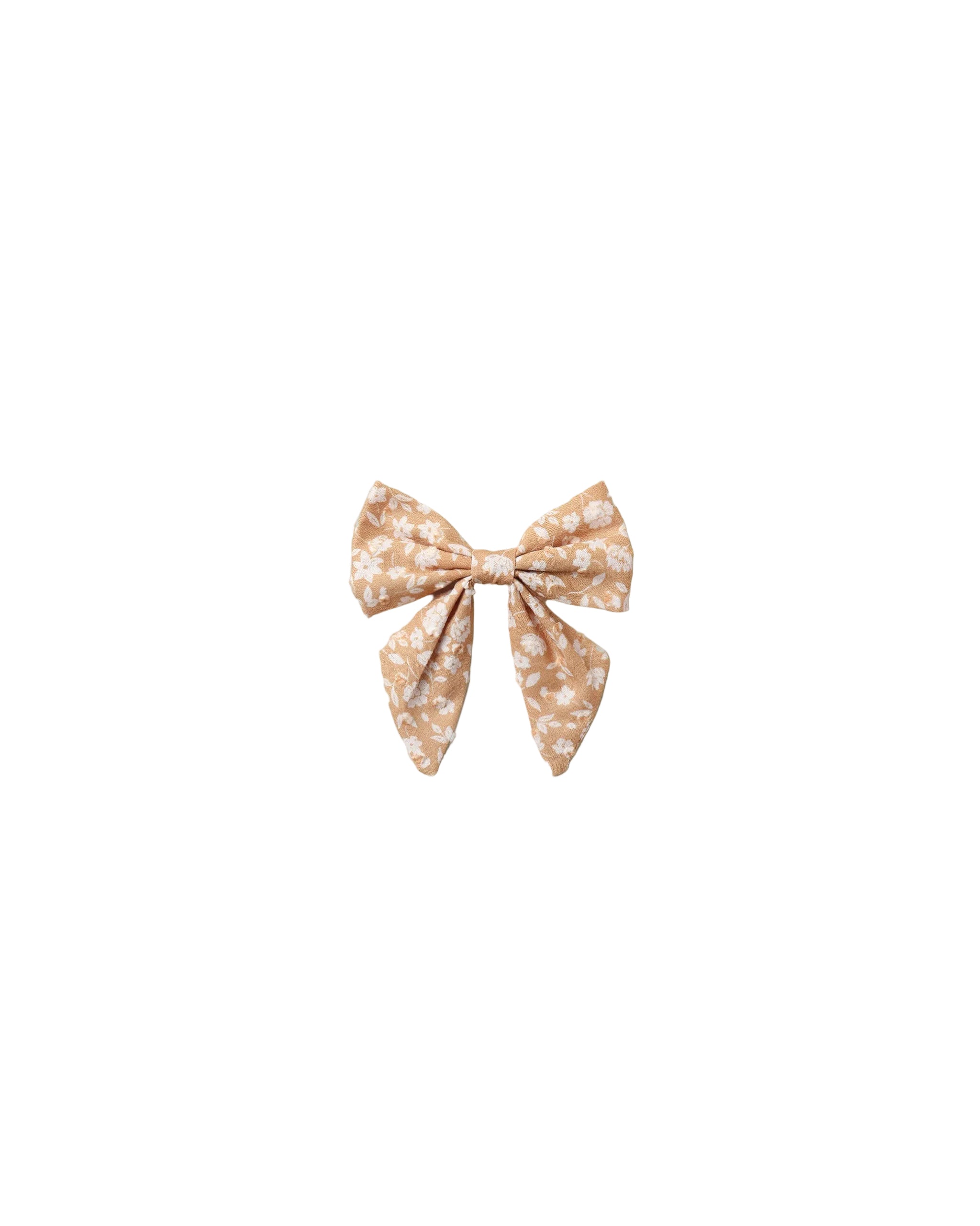 A small fabric bow accessory with a beige and white floral pattern, centered on a plain white background.