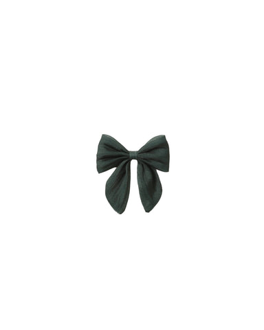 Dark green Noralee bow hair accessory displayed against a white background with softly folded loops and flowing tails