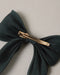 Noralee deep green bow on a rose gold alligator clip with soft gathered fabric and a polished finish for secure all day wear