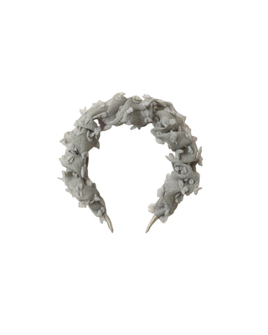 A light gray fabric headband with a textured, ruffled, fringed design and silver metal push-on ends, displayed on a white background.