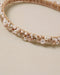 Beaded headband with pearls on a beige background