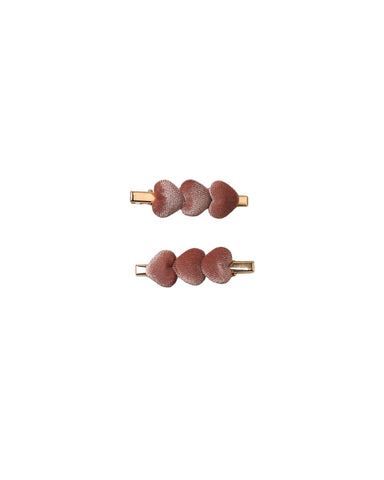Two small hair claw clips with three spice colored velvet hearts on a gold-tone metal base, arranged vertically on a white background.