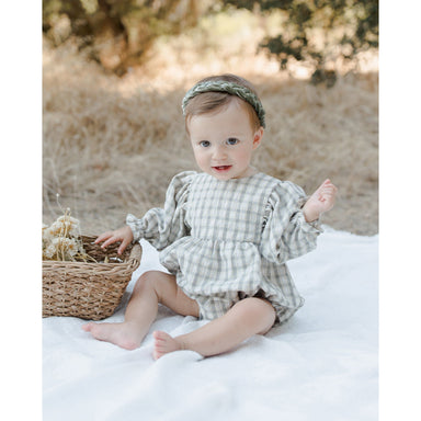 baby girl sitting up ivory long sleeve bubble with gathering at the waist and wrists with green plaid print