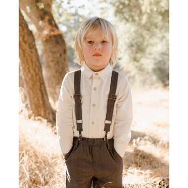 boy wearing charcoal black suspender pants with white button down dress shirt