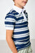 A child wearing a short-sleeve polo shirt with horizontal navy, white, and light blue stripes, paired with a white collar and light khaki pants.