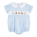 A baby romper in light blue and white gingham with a white Peter Pan collar, featuring a smocked chest band with embroidered cowboy boots, a horseshoe, and a small red heart.
