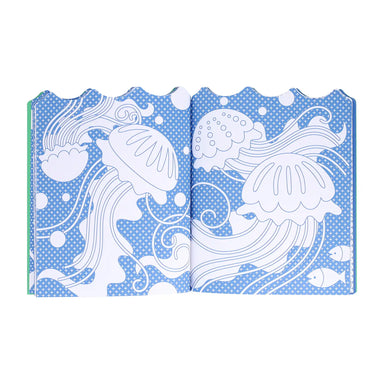 Open book with ocean-themed illustrations on a blue polka dot background
