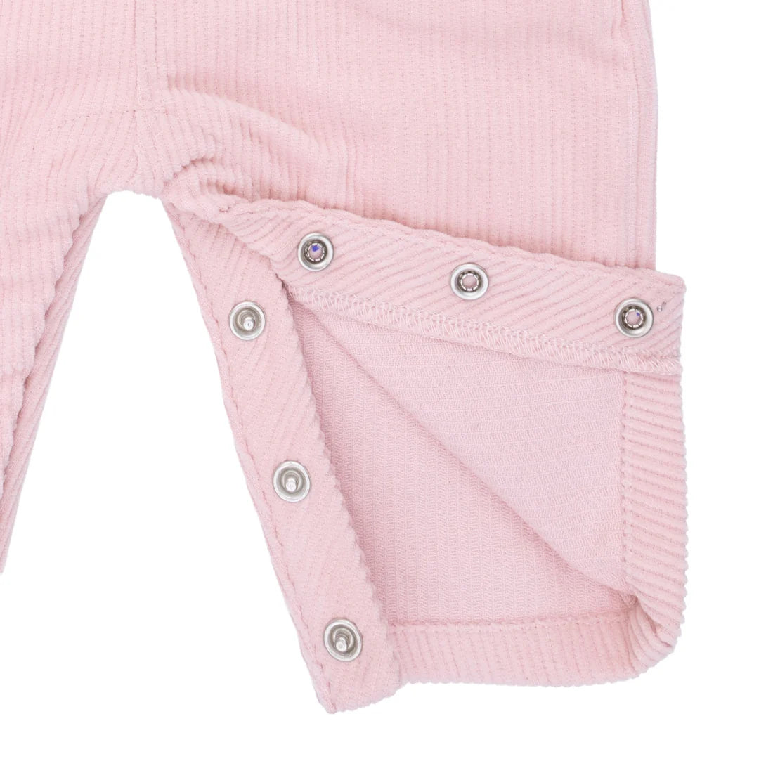 Close-up of a pink overall with snap details on a white background