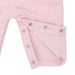 Close-up of a pink overall with snap details on a white background