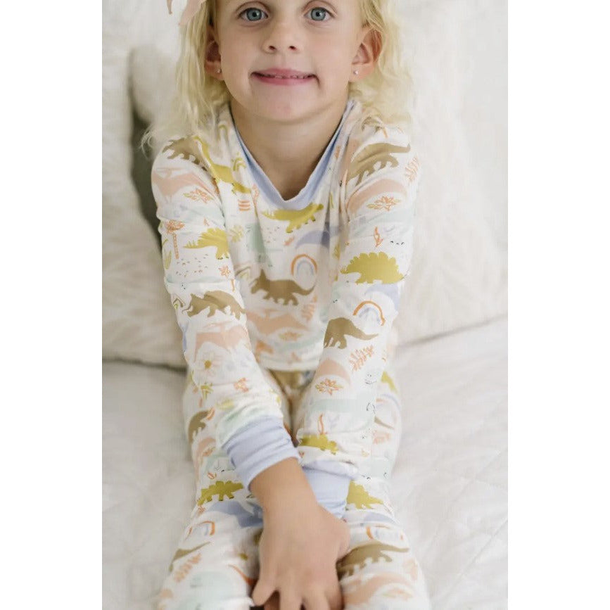 girl wearing two piece loungewear set with dainty dinosaur print