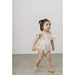 toddler wearing multicolor floral bubble romper with flutter sleeves