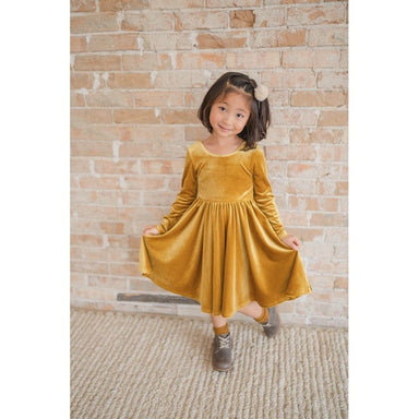 girl wearing long sleeve golden yellow velvet twirl dress