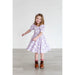 girl twirling in purple short puff sleeves dress with girly ghost print