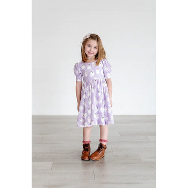 girl wearing purple dress with puff short sleeves and girly ghost pattern
