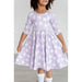 girl wearing 3/4 length sleeve purple dress with girly ghost print