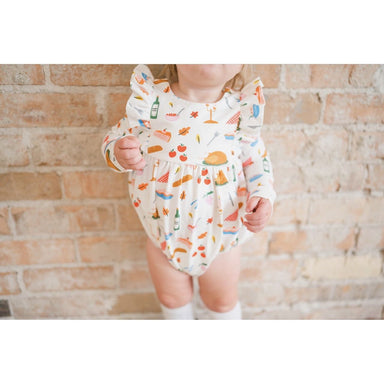 white long sleeve bubble romper with ruffle detail on sleeve in front and back and thanksgiving turkey print all over