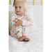 girl wearing white loungewear set with thanksgiving turkey print all over