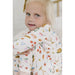 girl wearing white loungewear set with thanksgiving turkey print all over