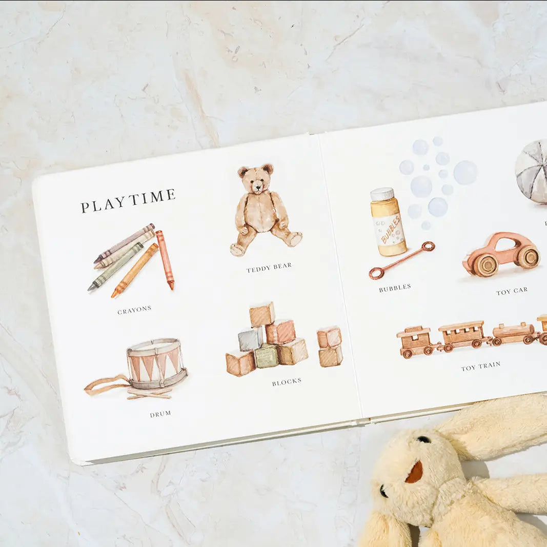 Children's book with illustrations of toys on a marble surface