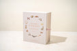 Book titled 'Our Little Library' with decorative illustrations on a white background