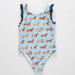 Children's swimsuit with dachshund pattern on a light blue background