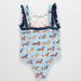 Children's swimsuit with dachshund pattern on a light blue background