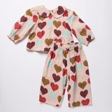 Pink Chicken baby girls two piece outfit with a soft pink top and matching pants featuring burgundy olive and seafoam hearts and a Peter Pan collar