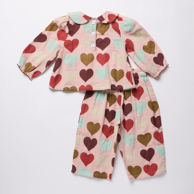 Pink Chicken baby girls two piece outfit with a Peter Pan collar and pintuck detail featuring multicolor hearts on a soft pink background with coordinating pants