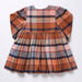 Pink Chicken girls dress in warm Hayride plaid with long sleeves gathered waist and full skirt displayed against a light background