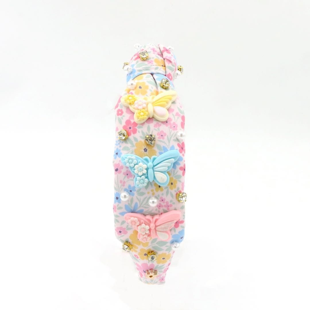 Decorative headband with colorful butterflies and flowers on a white background