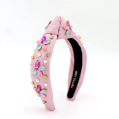 Pink headband with decorative elements on a white background