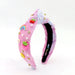 Pink headband with colorful decorations on a white background