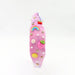 Pink hairband with decorative elements on a white background