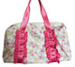 Pink and multicolored patterned bag with ruffles on a white background