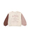 A children's long-sleeve sweatshirt with a cream body, dusty pink sleeves, and a brown sleeve on the left side. The front features a dusty pink graphic reading 'APRÈS Ski Club' with a cross-ski design.