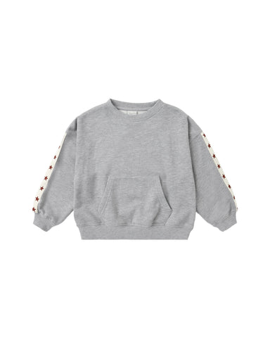 A light gray heather crewneck sweatshirt with a front kangaroo pocket and decorative white stripes on the sleeves featuring small red star details, shown on a plain white background.