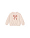 Beige sweatshirt with a pink bow design on a white background
