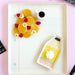 Plated dessert with pancakes, fruit, and a small cup on a pink surface