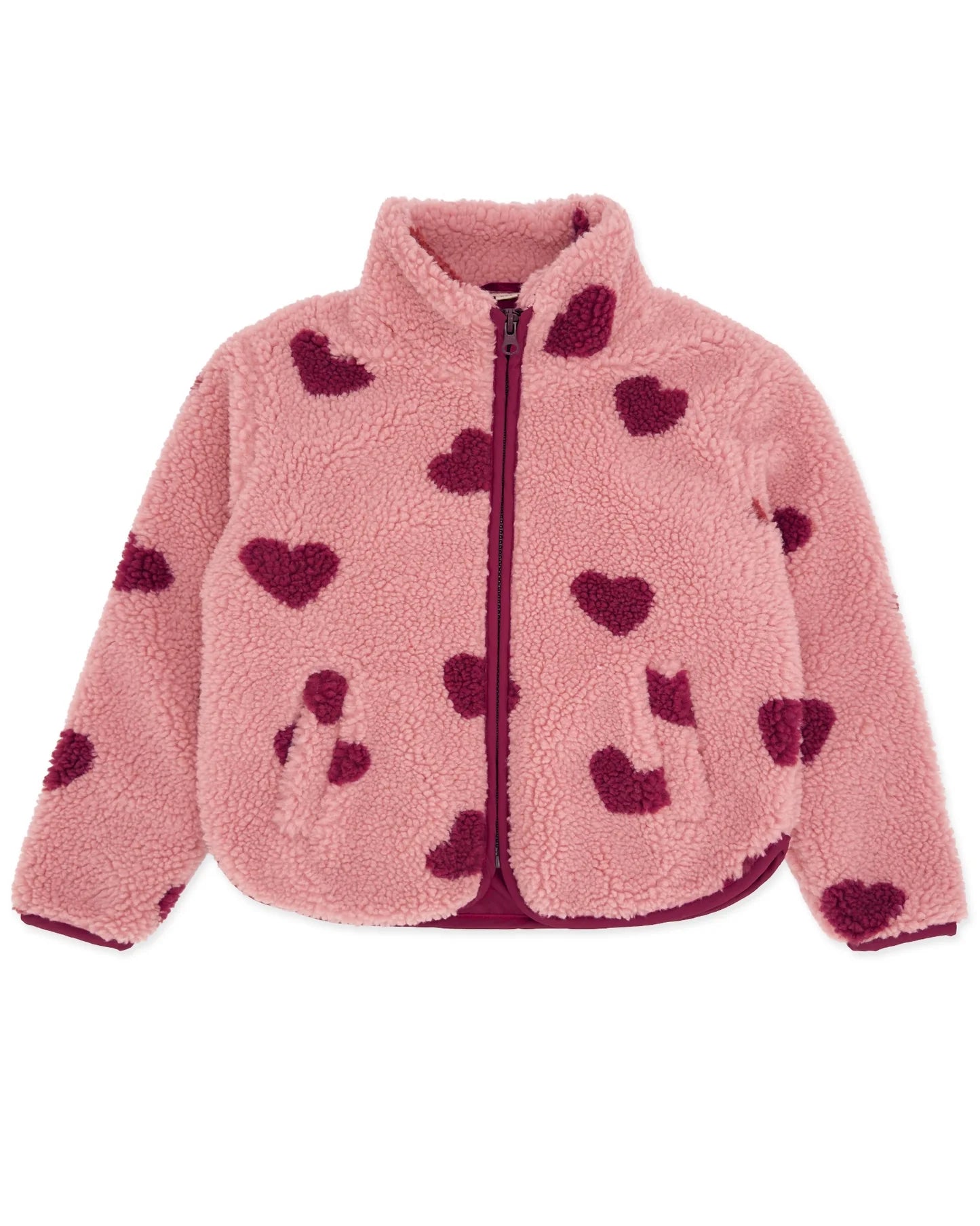 A pink sherpa jacket that has a front zipper with dark pink hearts
