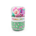 Pastel Christmas sensory dough jar with green sprinkle filled dough and a clear top compartment holding a Santa figure and colorful holiday accessories by Young Wild and Friedman