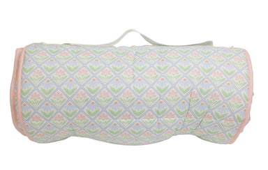 Roll-up nap mat with pastel floral pattern on a white background