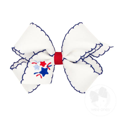 White bow with red and blue fireworks accents on a white background