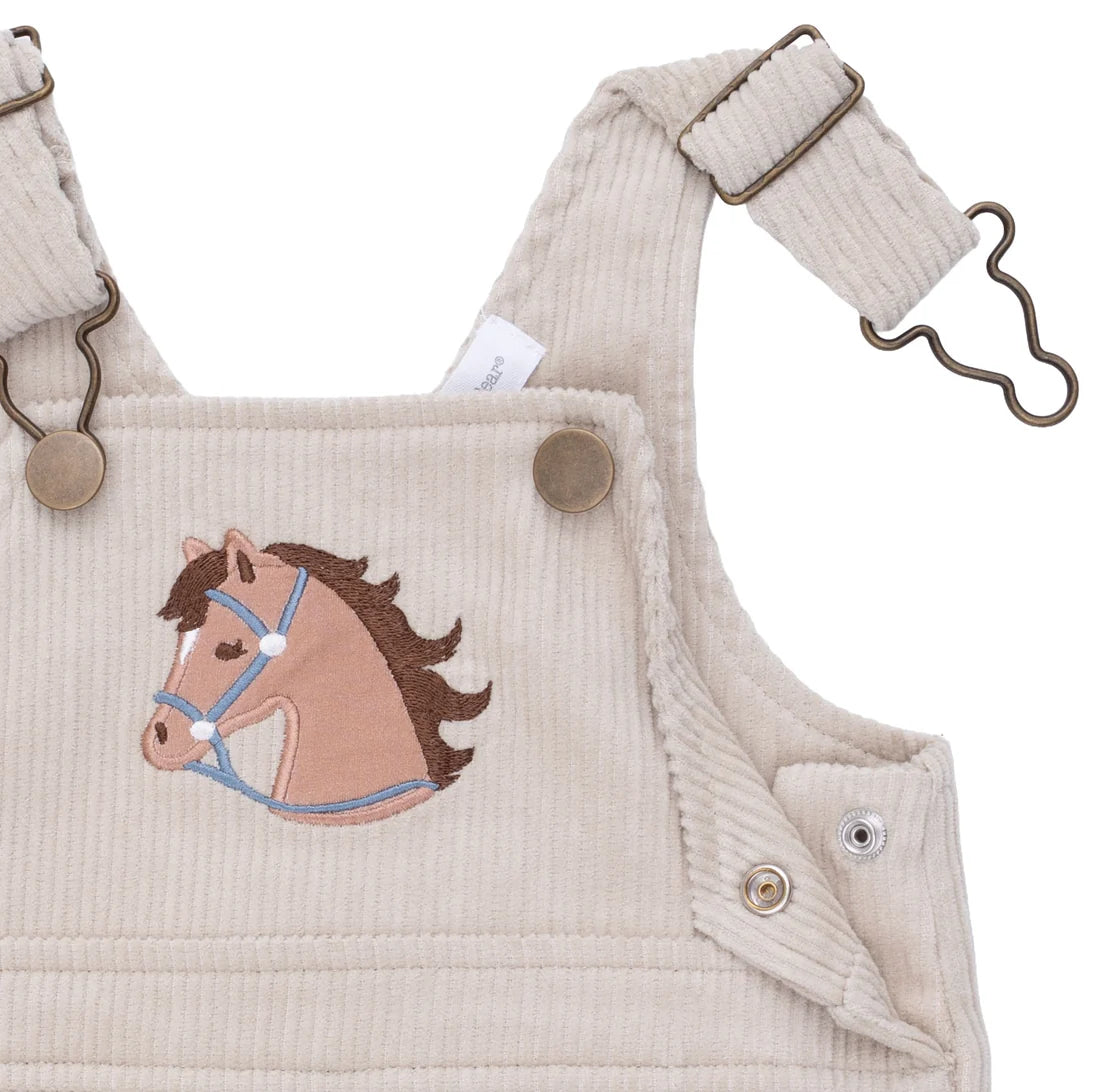Beige corduroy overalls with a horse applique on a white background